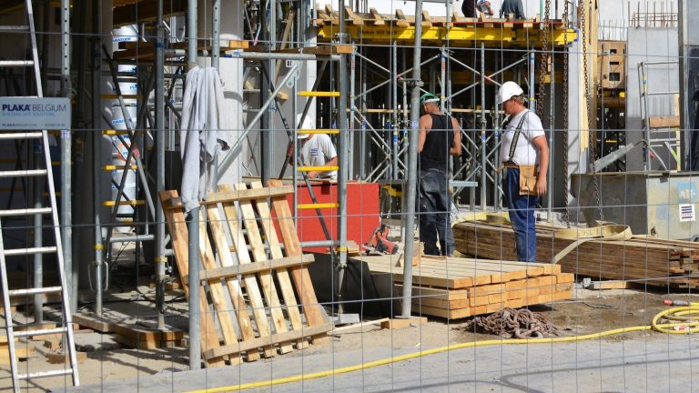 man in blue denim jacket standing beside man in blue denim jacket