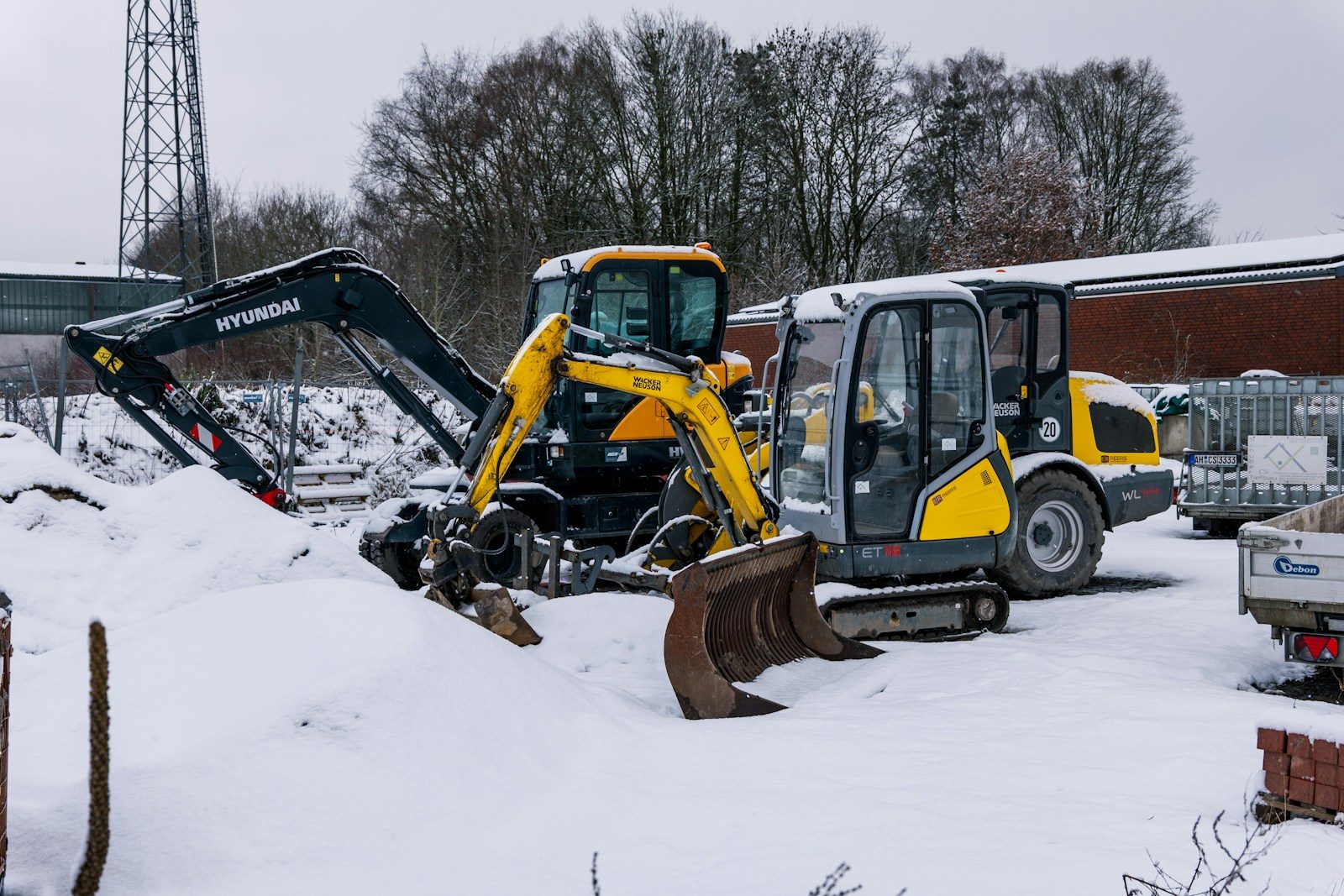 Two excavators parked in the snow